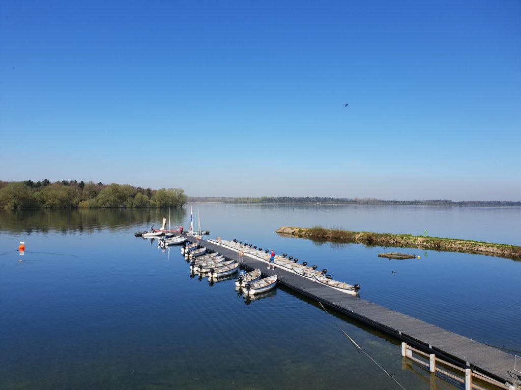 Drone shot of the Hanningfield Reservoir dock with speedboats docked on either side